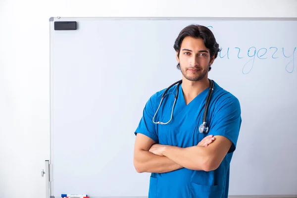 Young male doctor in front of whiteboard — Stock Photo, Image