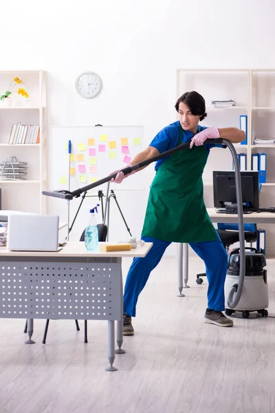 Male handsome professional cleaner working in the office