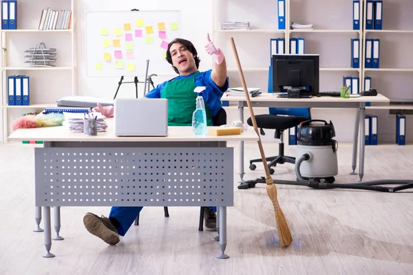 Male handsome professional cleaner working in the office