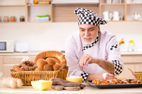 Régi férfi baker dolgozik a konyhában — Stock Fotó