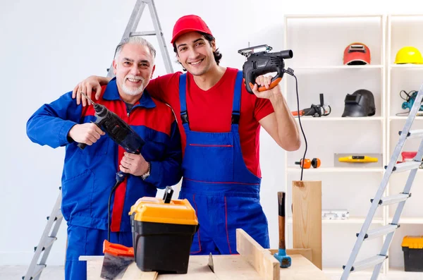 Two professional contractors laying flooring at home