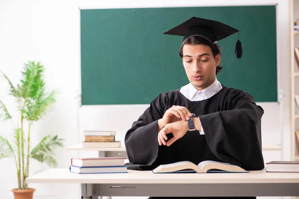 Graduate student in front of green board — Stock Photo, Image