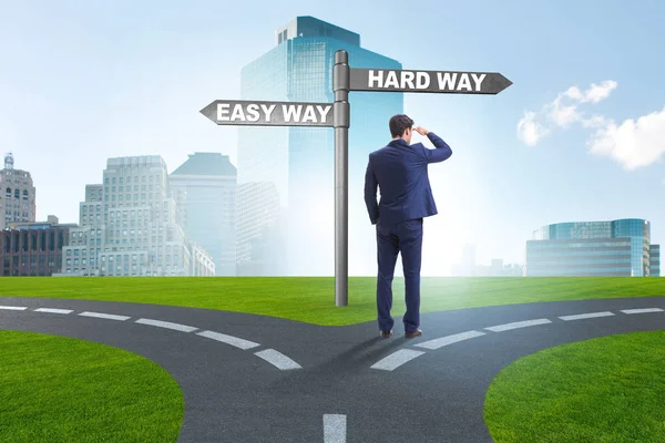 Businessman choosing between hard and easy way — Stock Photo, Image