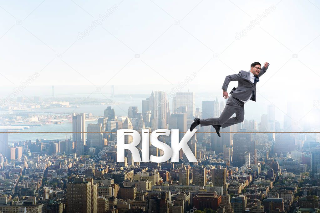 Businessman in risk concept walking on tight rope
