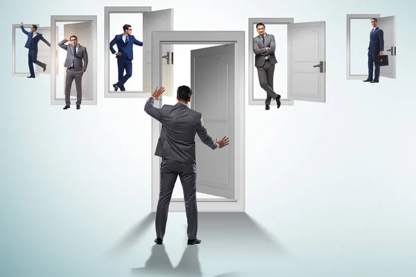 Businessman in uncertainty concept with many doors — Stock Photo, Image