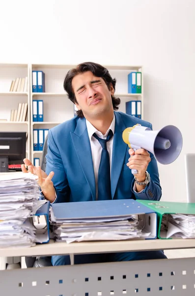 Young handsome busy employee sitting in office — Stock Photo, Image