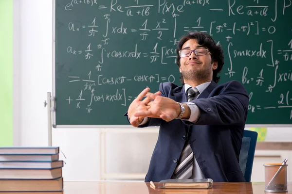 Young male math teacher in classroom — Stock Photo, Image