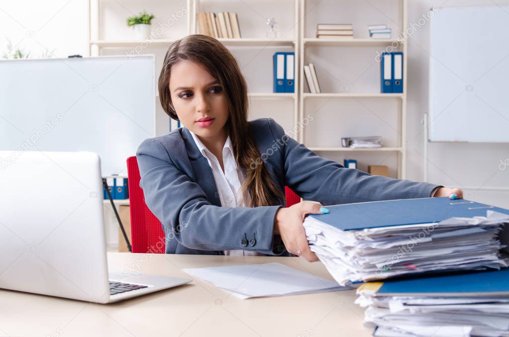 Beautiful female employee unhappy with excessive work 