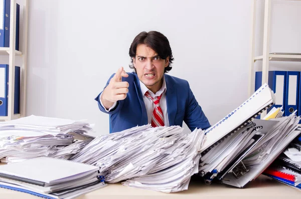Young businessman employee unhappy with excessive work — Stock Photo, Image