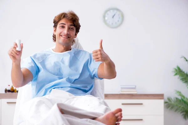 Young male patient lying on couch in hospital