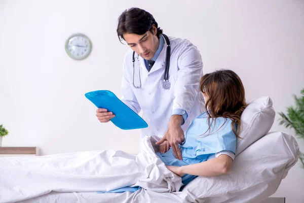 Médico visitando paciente feminina na enfermaria — Fotografia de Stock