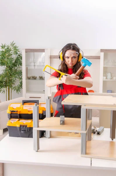 Female contractor repairing furniture at home