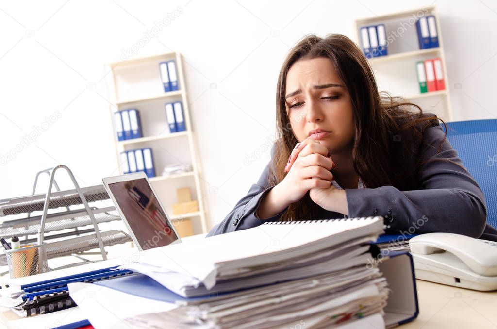 Young female employee unhappy with excessive work 