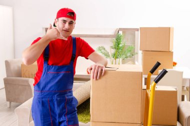 Young contractor with boxes working indoors  clipart