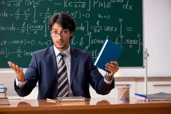 Young male math teacher in classroom — Stock Photo, Image