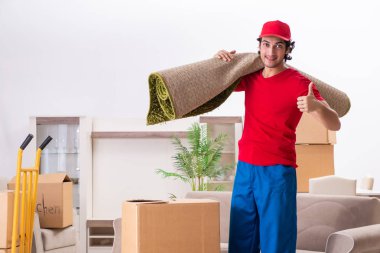 Young male contractor with boxes working indoors  clipart
