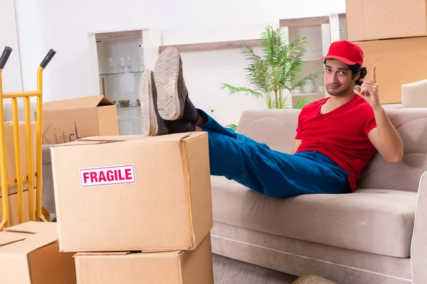 Young male contractor with boxes working indoors — Stock Photo, Image