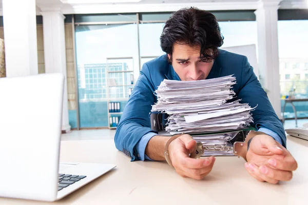 Chained male employee unhappy with excessive work — Stock Photo, Image