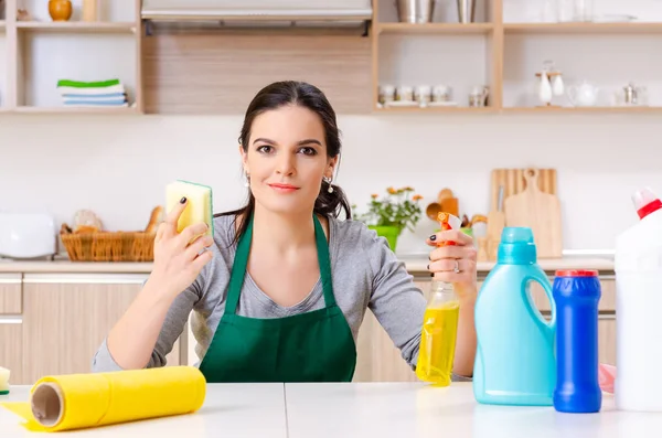 Young female contractor doing housework — Stock Photo, Image