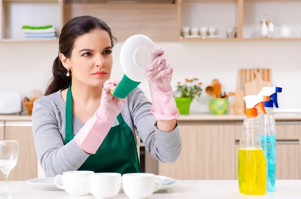 Young female contractor doing housework — Stock Photo, Image