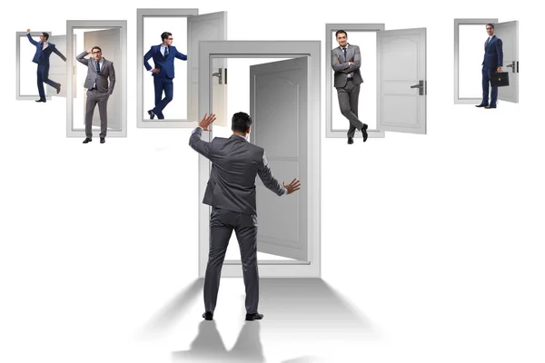 Businessman in uncertainty concept with many doors — Stock Photo, Image