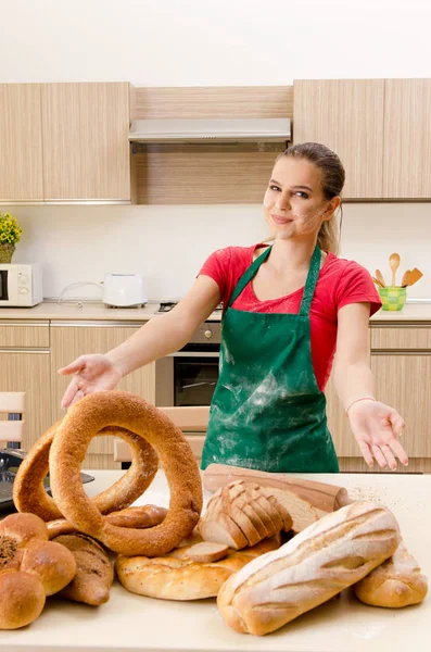 Young female baker working in kitchen — Stock Photo, Image