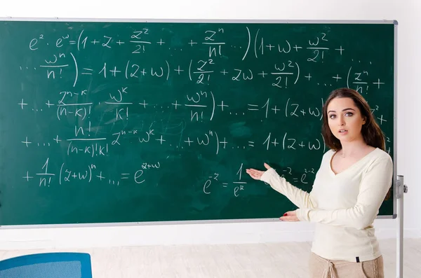 Молода вчителька математики перед дошкою — стокове фото