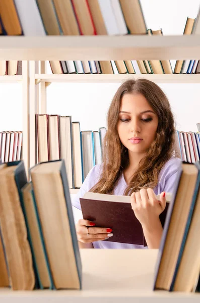 Young female student preparing for exams at library — Stock Photo, Image