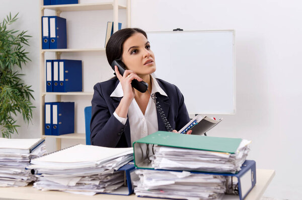 Работница, у которой слишком много работы в офисе
 