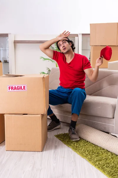 Joven contratista masculino con cajas trabajando en interiores — Foto de Stock