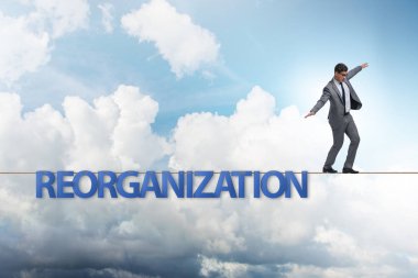 Reorganisation concept with businessman walking on tight rope clipart