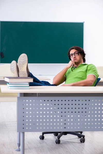 Young male student in front of green board — Stock Photo, Image