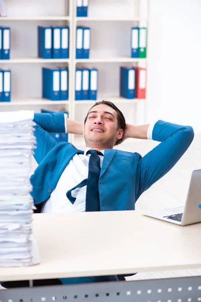 Young male employee unhappy with excessive work — Stock Photo, Image