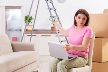 Ev geliştirme kavramı içinde laptop ile orta yaşlı kadın 