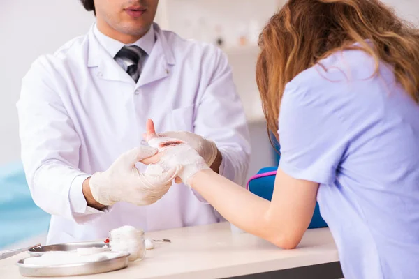 Mujer lesionada de la mano que visita al médico traumatólogo —  Fotos de Stock