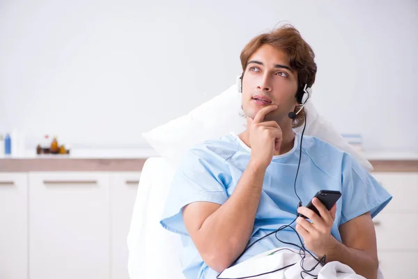 Young male patient lying on couch in hospital