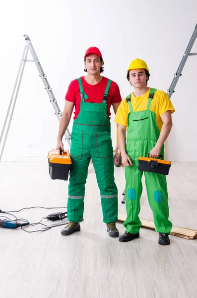 Two workers contractors working indoors