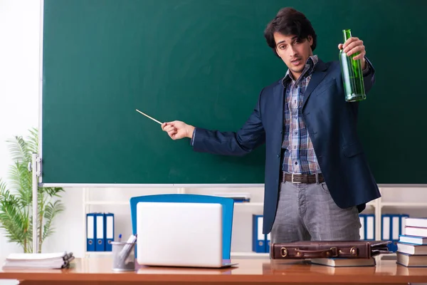 Male teacher drinking in the classroom — Stock Photo, Image