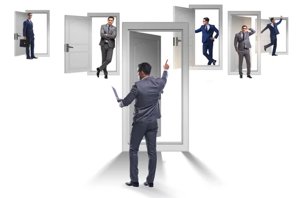 Businessman in uncertainty concept with many doors — Stock Photo, Image