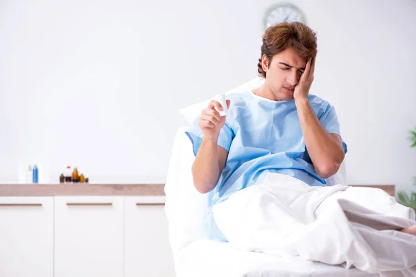 Young male patient lying on couch in hospital