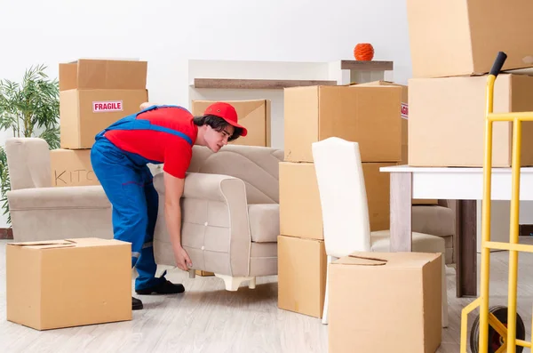 Young male contractor with boxes working indoors — Stock Photo, Image