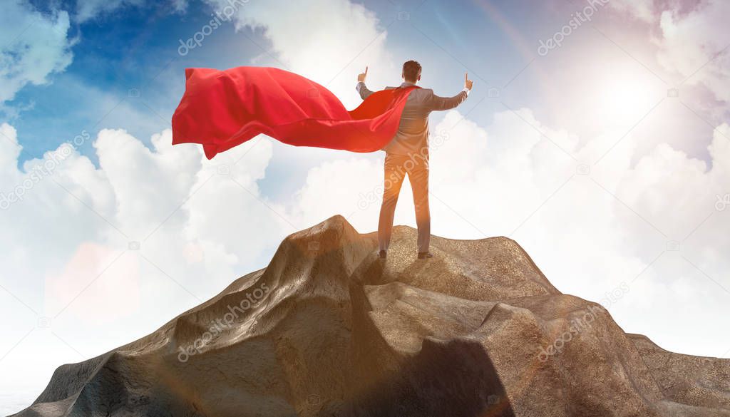 Superhero businessman on top of mountain