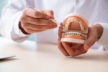 Klinikte çalışan erkek doktor stomatolojisti. 