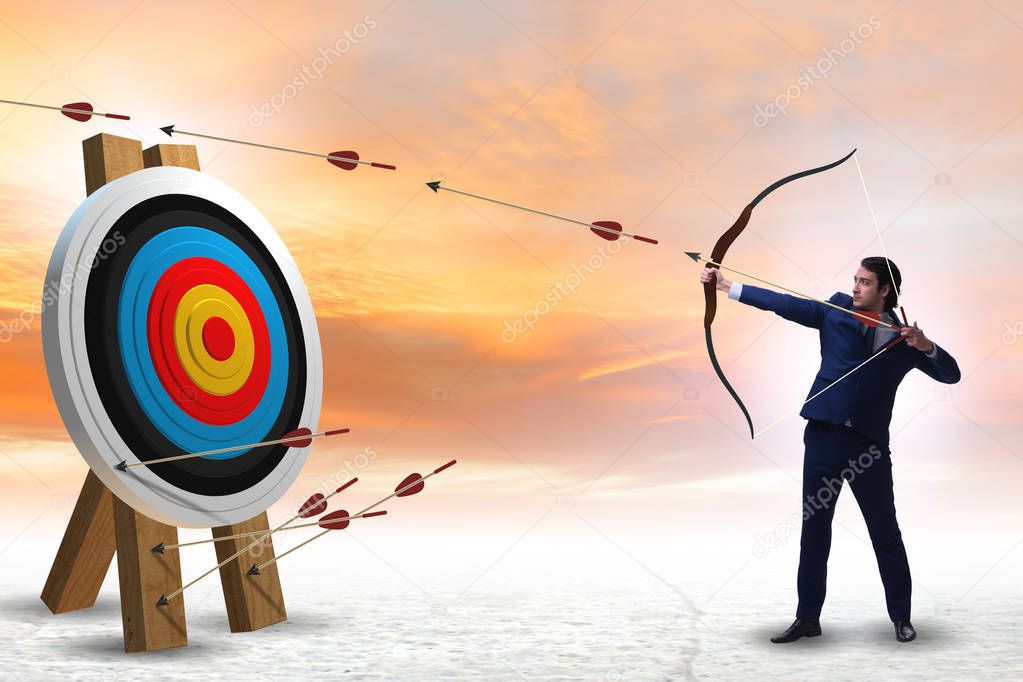 Businessman aiming arrow with bow