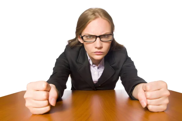 Vrouwelijke werknemer zit aan lange tafel geïsoleerd op wit — Stockfoto