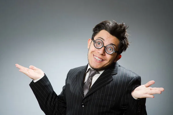 Funny nerd businessman in dark studio — Stock Photo, Image