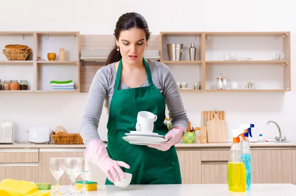 Young female contractor doing housework — Stock Photo, Image