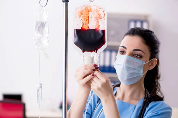 Young female doctor in infusion concept — Stock Photo, Image