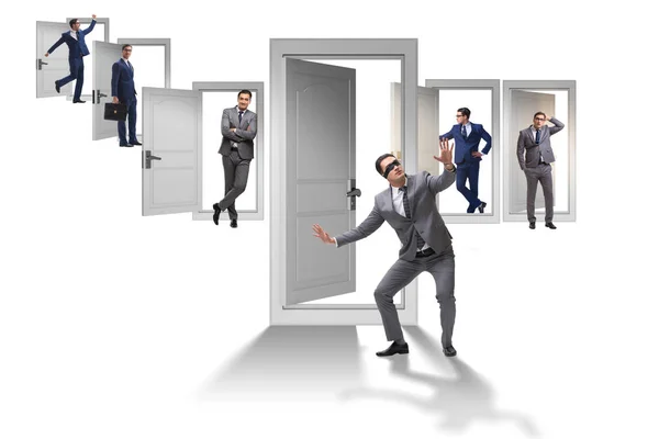 Businessman in uncertainty concept with many doors — Stock Photo, Image