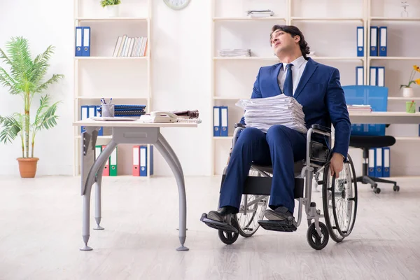 Junge männliche Angestellte im Rollstuhl bei der Arbeit im Büro — Stockfoto